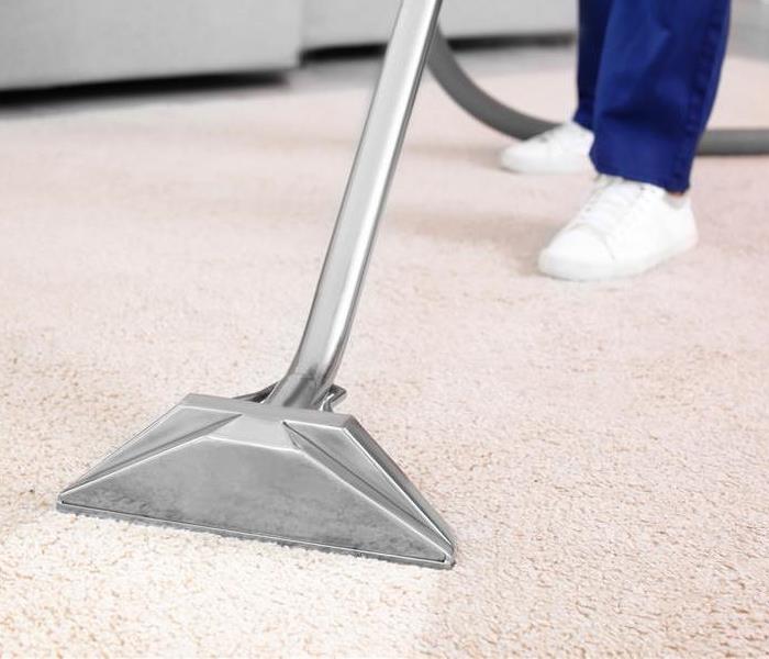 Commercial cleaner removing dirt from commercial property carpeting